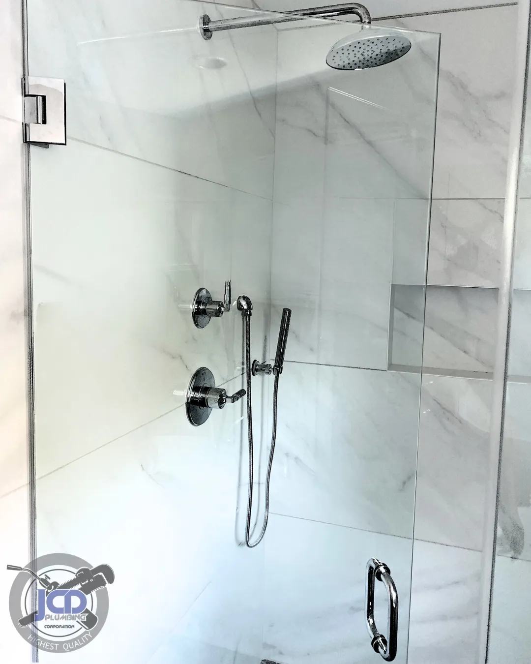 High-end glass shower enclosure with precision plumbing and modern fixtures in a residential bathroom renovation