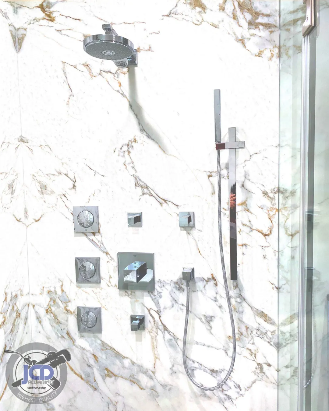 Custom shower plumbing installation with multi-function controls set into a marble wall as part of a luxury bathroom remodel