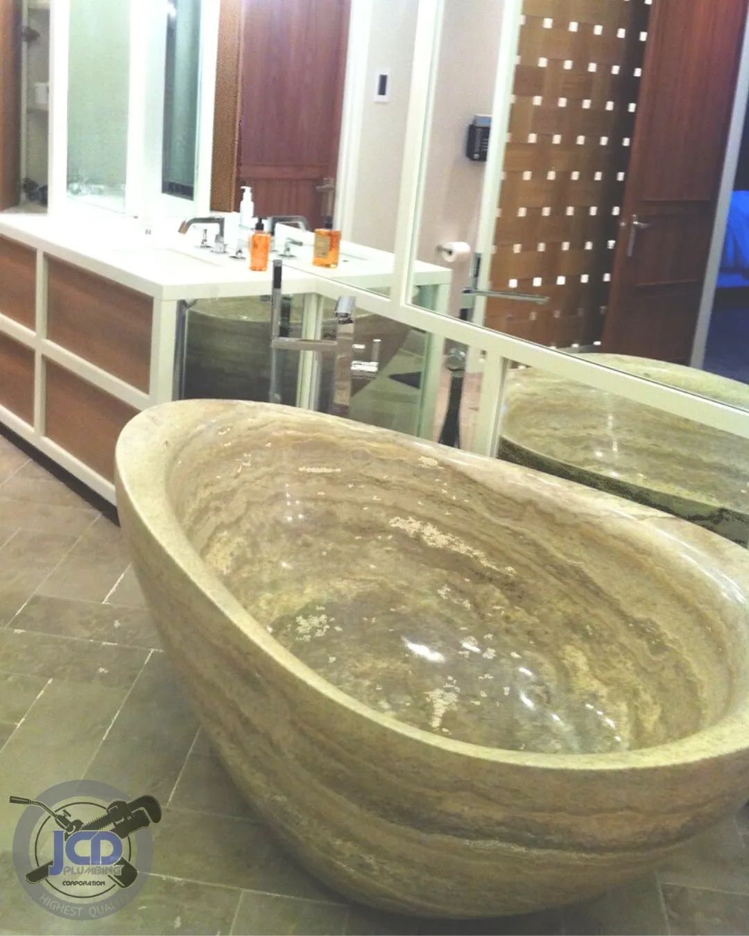 Luxury stone soaking tub installation completed during a high-end residential bathroom renovation