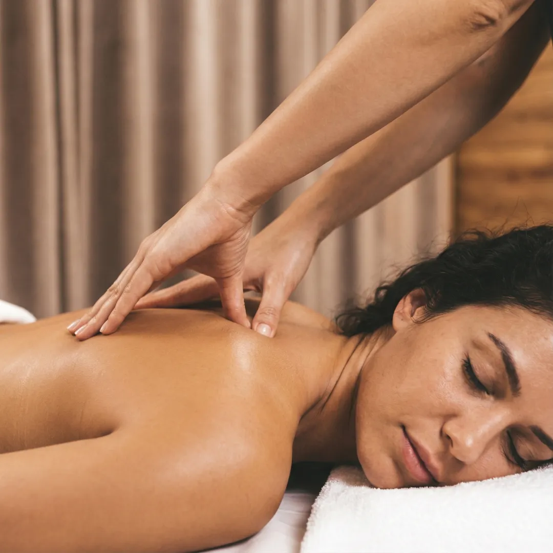 Therapist performing deep tissue back massage with slow, focused pressure