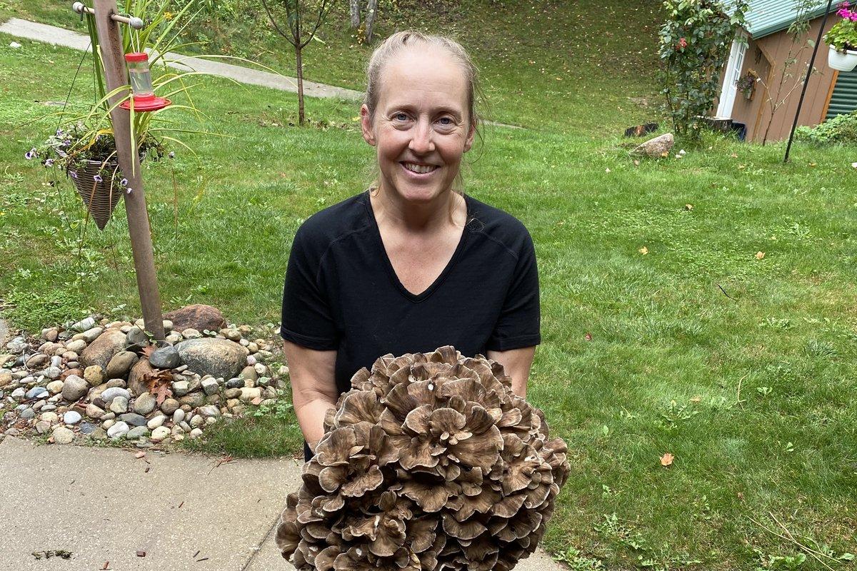 Kelly of Fungi, Flora & Ferment holding a large wild hen of the woods (maitake) she found