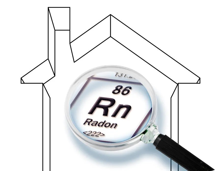 Magnifying glass examining radon symbol over house outline representing advanced radon testing in Charlotte, NC | Charlotte Home Inspector Pros