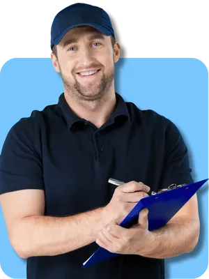 Smiling male home inspector in navy uniform holding a clipboard, ready to perform a home inspection