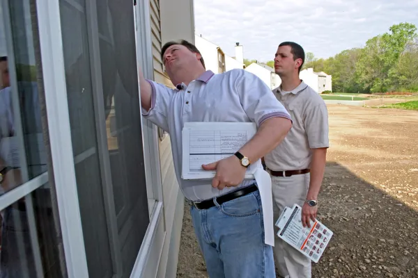 Inspector reviewing a checklist with homeowner before listing the house for sale.