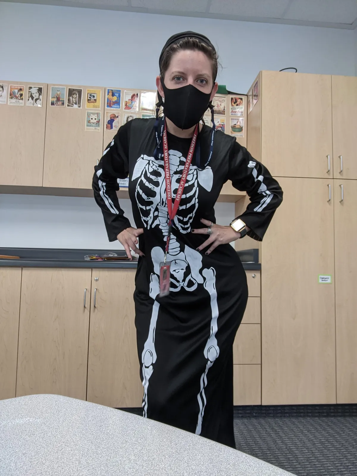 Tara wearing a Halloween skeleton costume with a mask