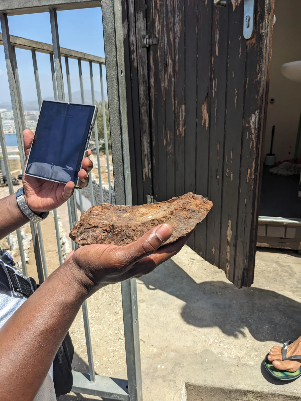 Ken holding a piece of an old cannonball