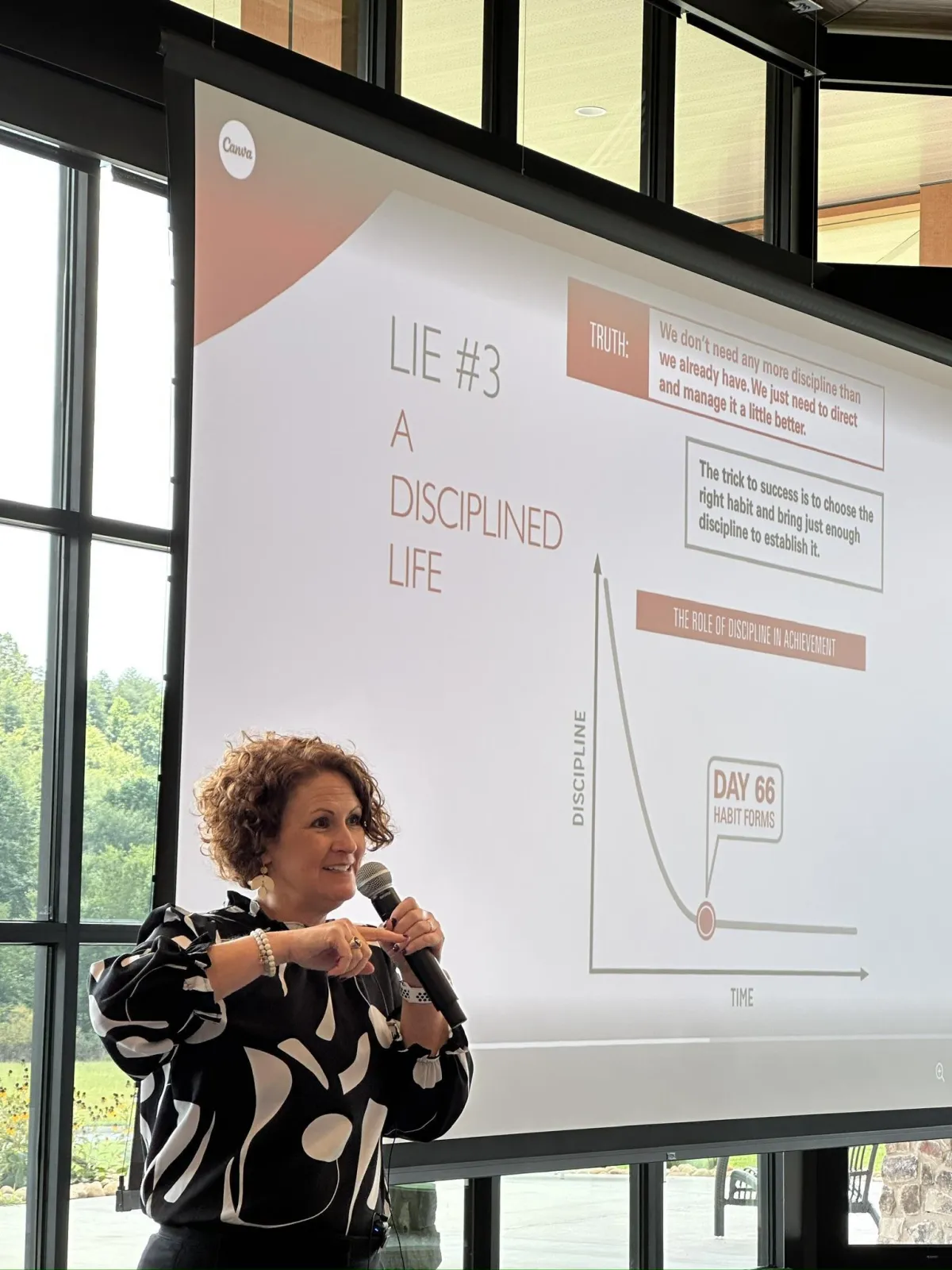 Dawn delivering a dynamic keynote presentation to an engaged audience