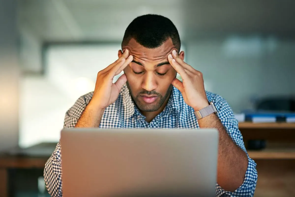 Man struggling at work because of lack of quality sleep