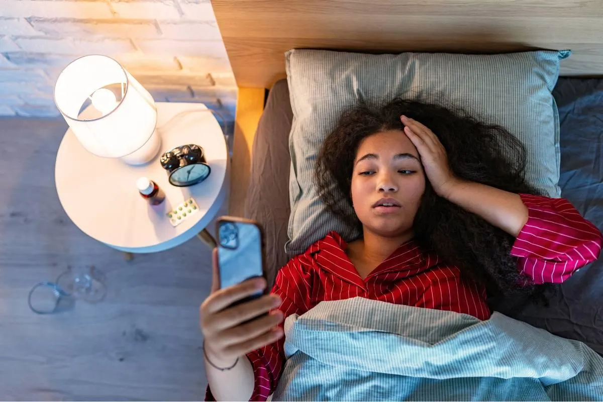 Woman can't sleep and is looking at the time