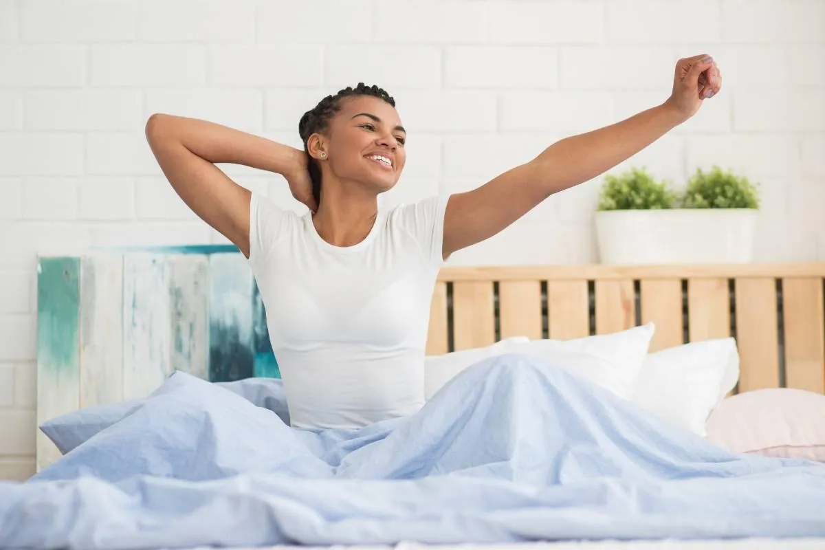 Woman waking up after having a great night's sleep