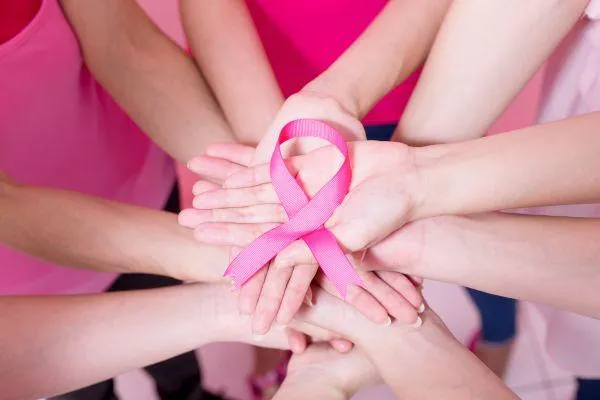 Women coming together at a retreat during Breast Cancer Awareness Month