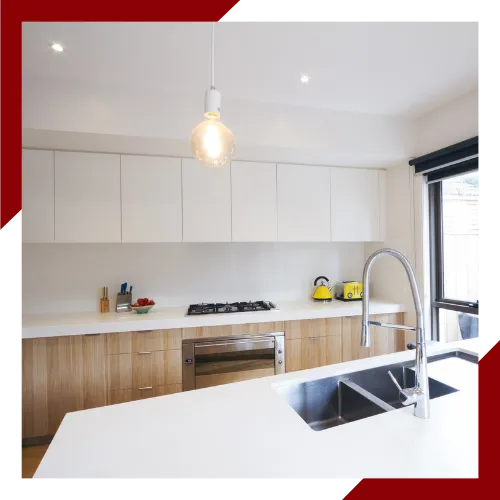 Modern kitchen design with clean cabinets, open space, and warm lighting