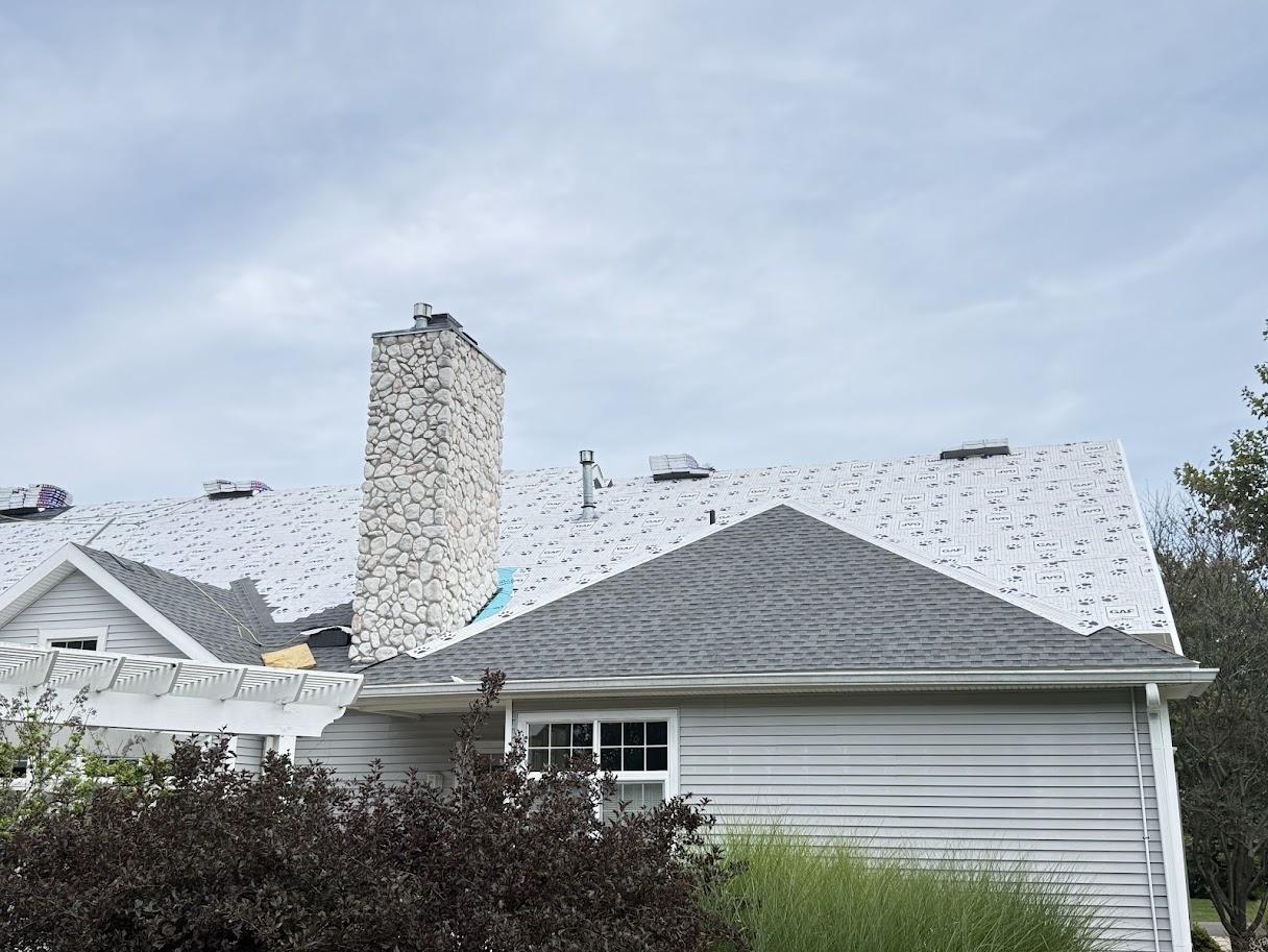 Close-up of a roof valley with dark gray shingles.