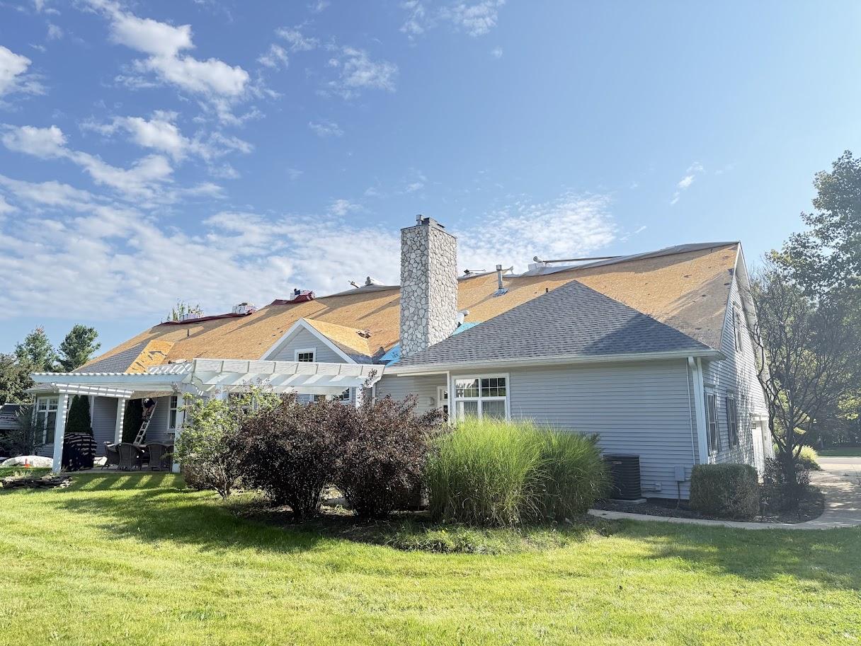 Aerial view of the house showing the full roof structure and surrounding property.