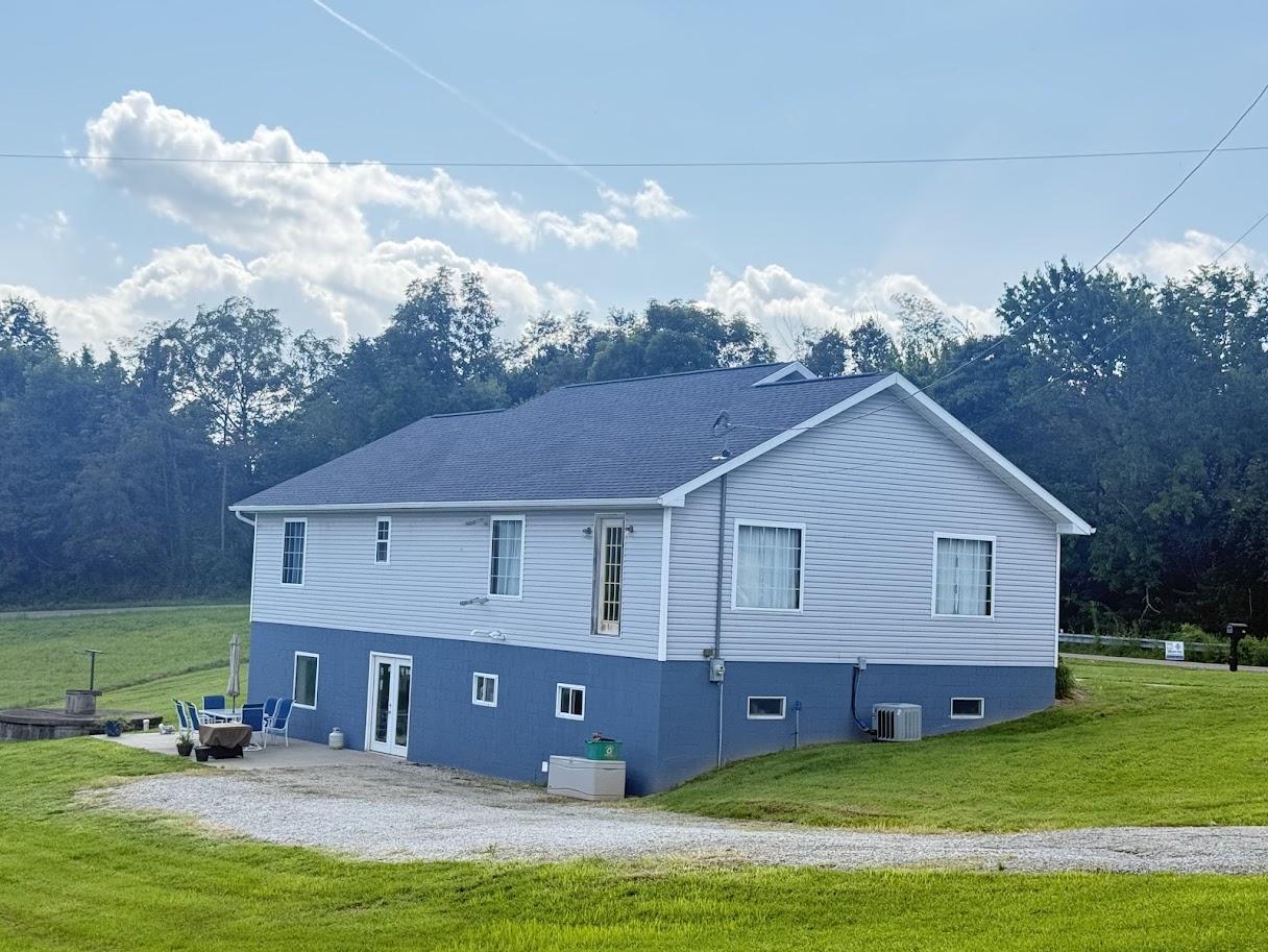 Aerial view of the house showing the full roof structure and surrounding property.