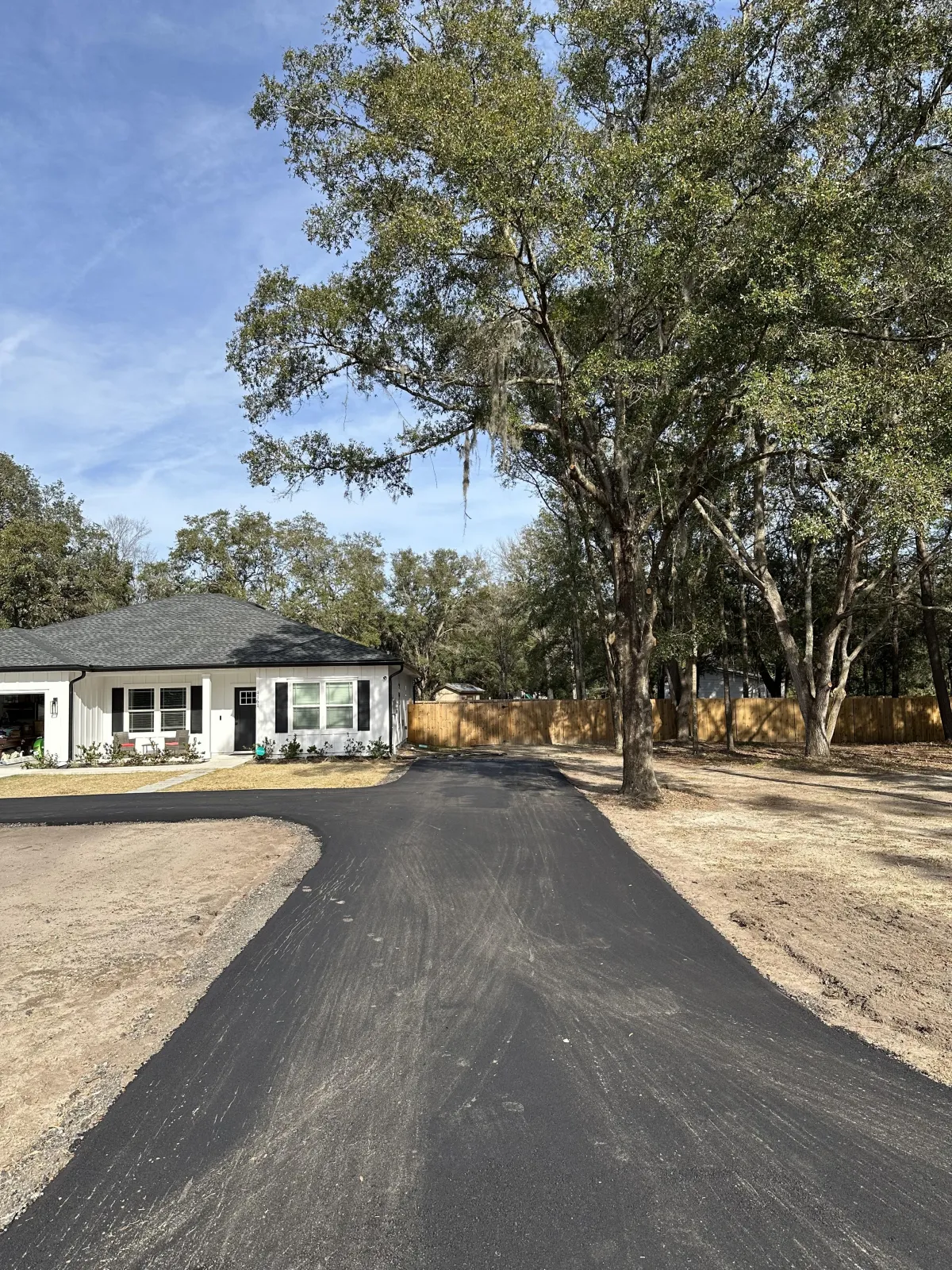 New asphalt paving installation in Miami, Florida, creating a smooth, durable driveway for a residential property.