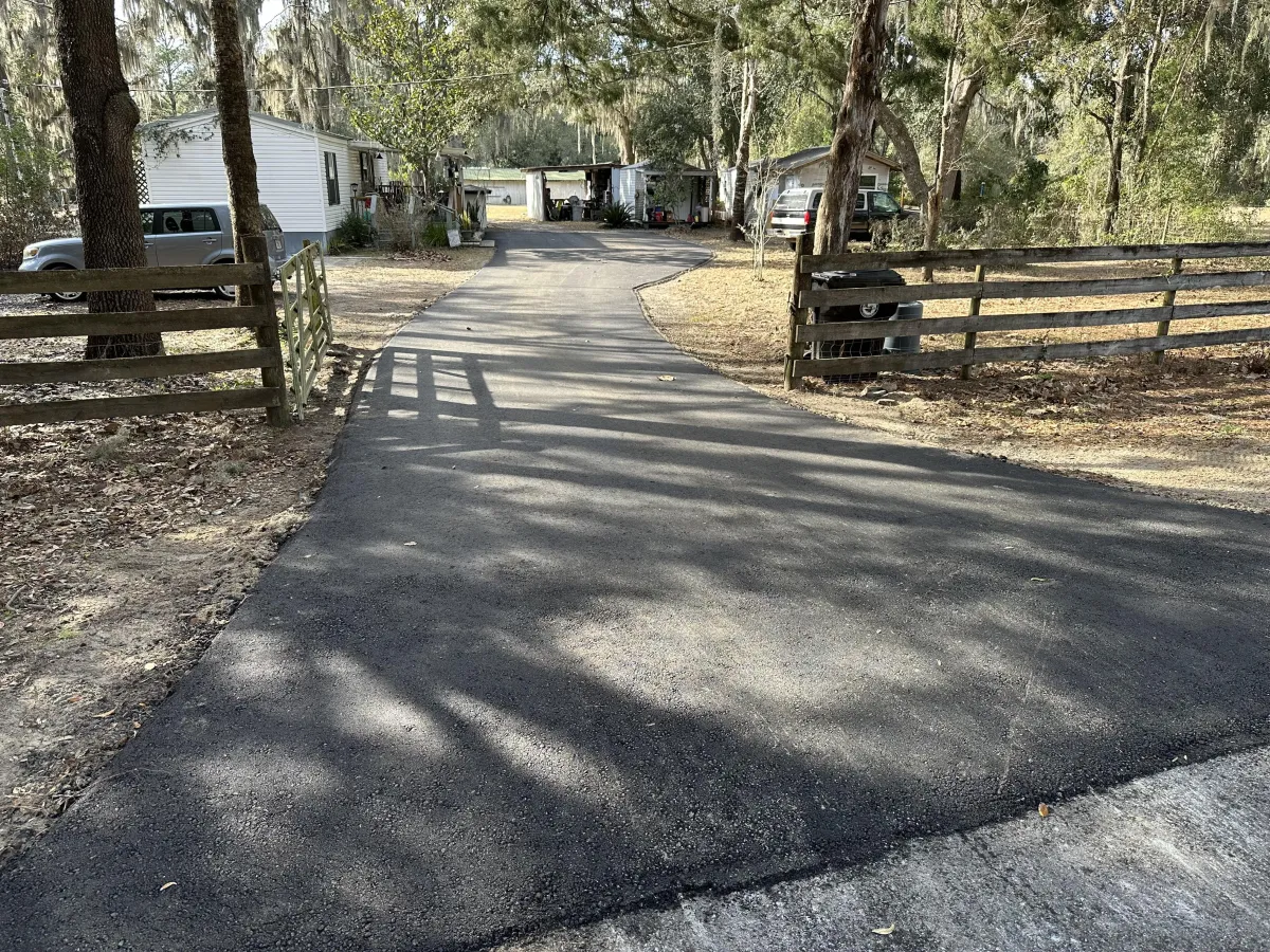 Experienced paving contractor performing a new asphalt paving installation for a residential driveway in Miami, Florida.