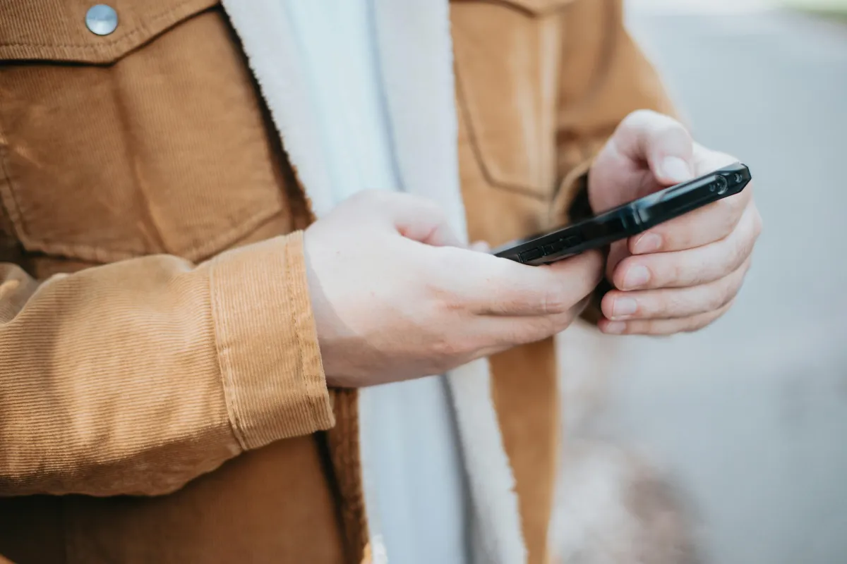 Image of man holding phone