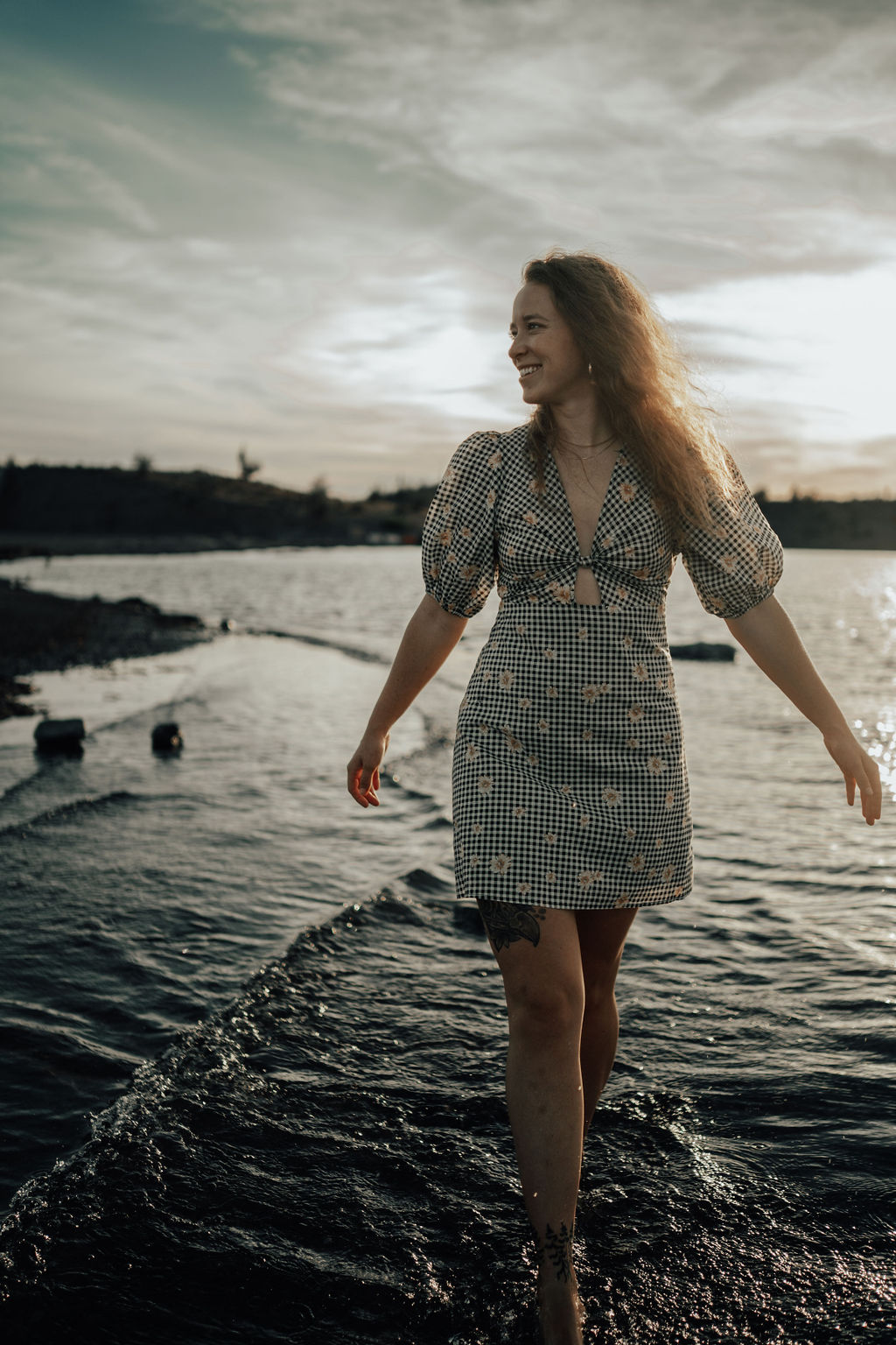 a man standing on a beach looking at the ocean