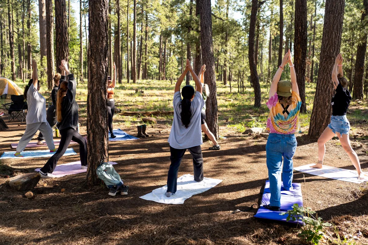 Stylish woman poses next to a reflective wall.