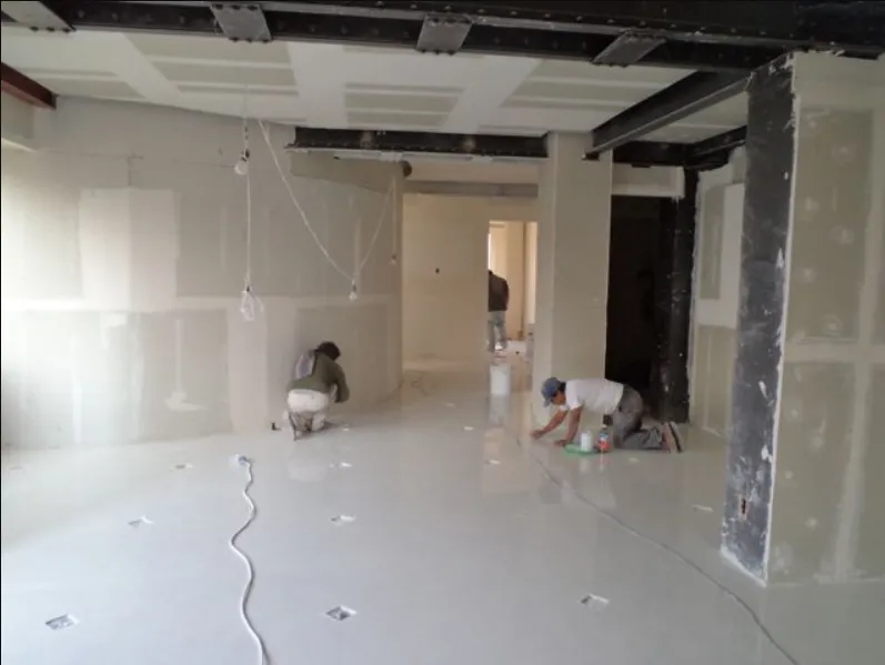 a tall building with lots of windows next to a tree