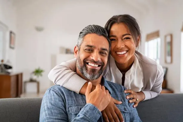 man and woman sitting on sofa in a room