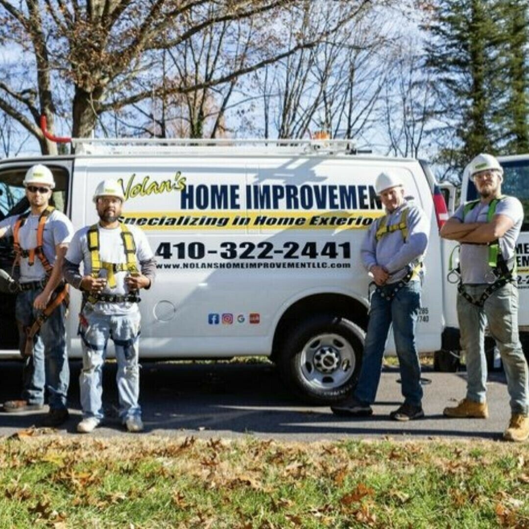 Nolan's Home Improvement crew standing proudly in front of a Middle River home after a successful roofing project.