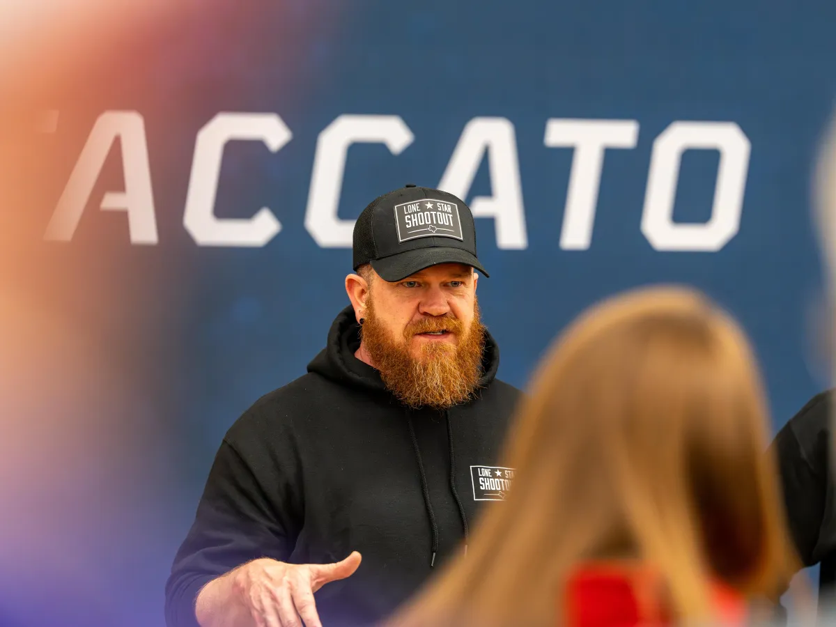 man standing in front of crowd coaching and speaking