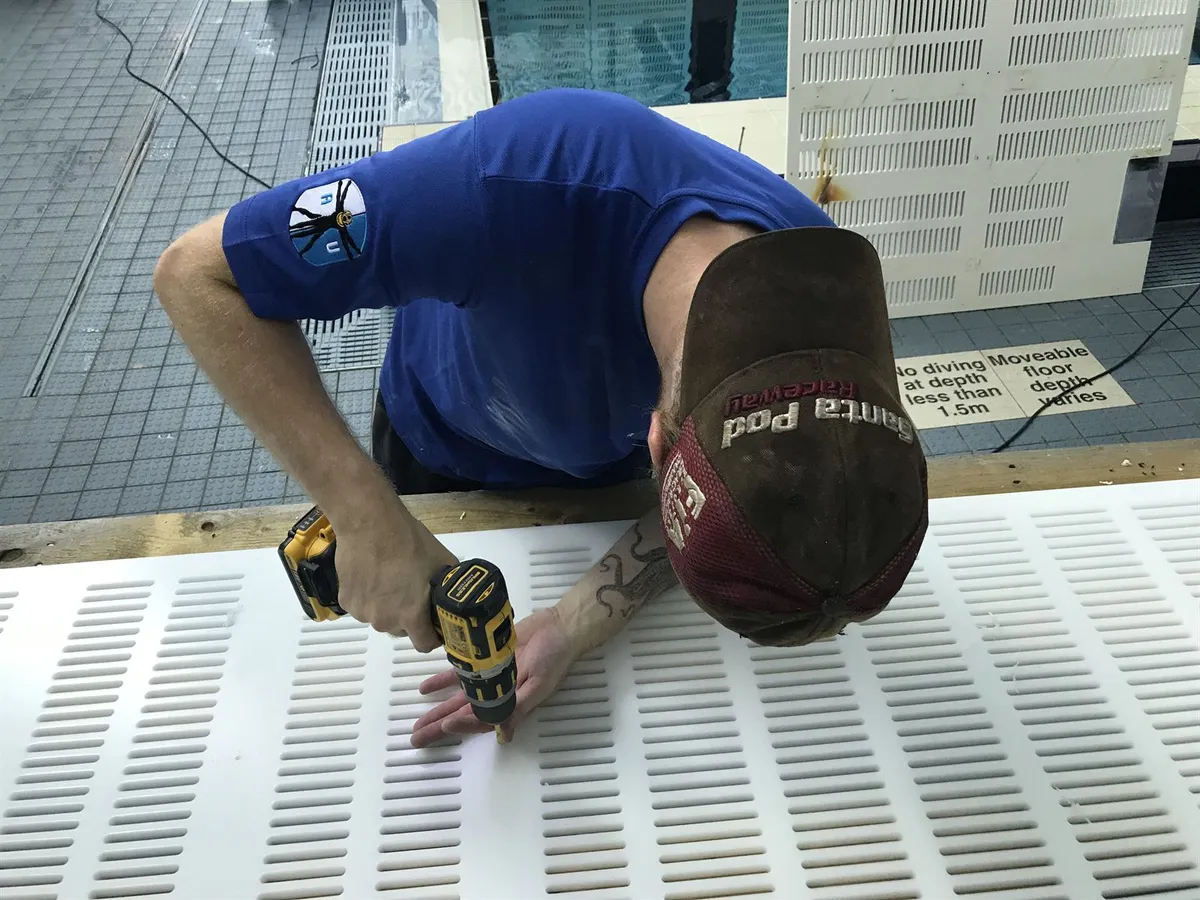 Access Underwater technician fixing moveable pool floor decking panels