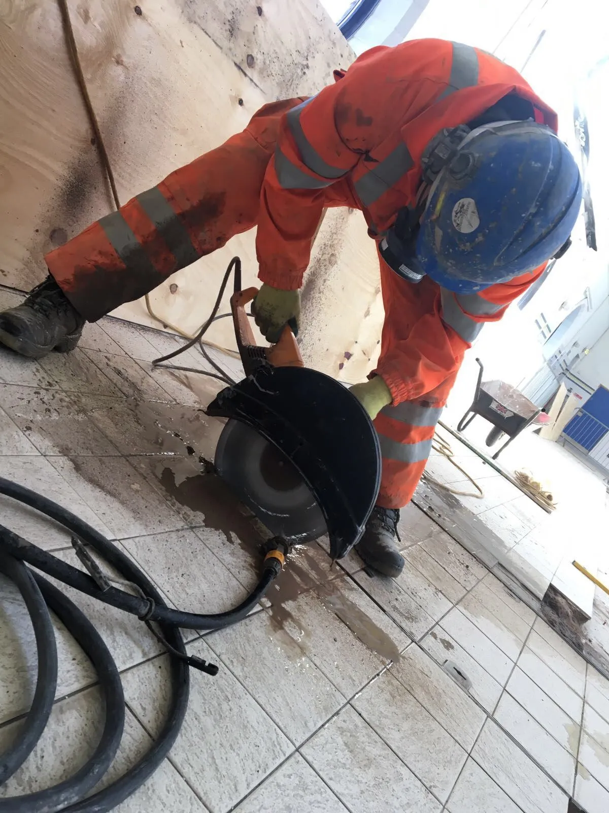 Access Underwater technician cutting tiles on a swimming pool surround