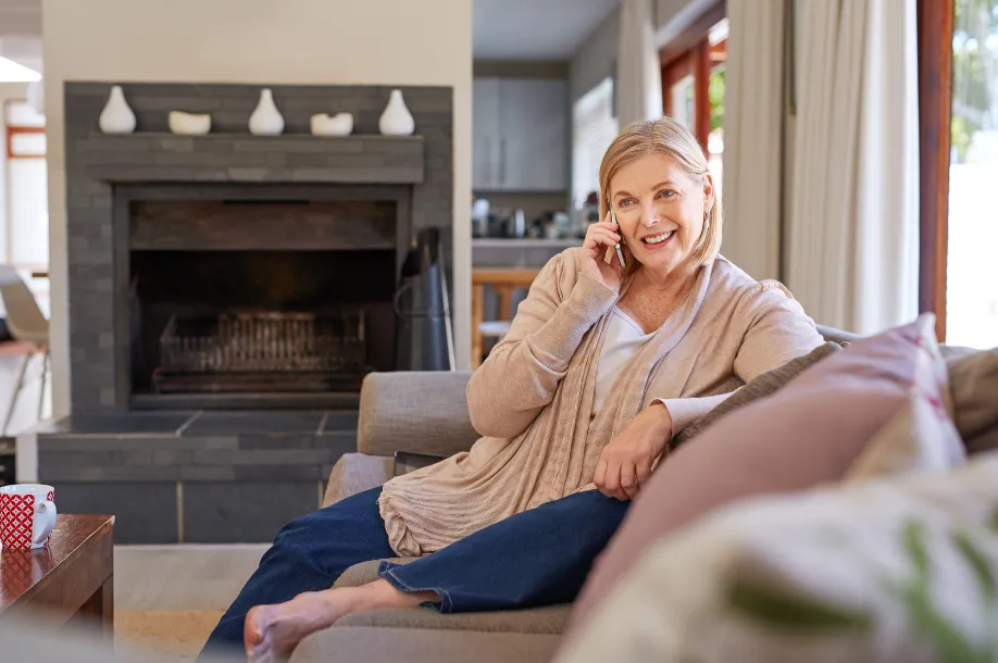 woman calling house cleaning services from comfortable living room