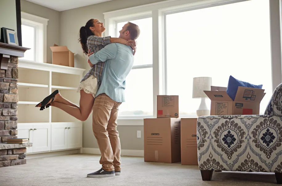 excited couple in empty apartment ready for move-in cleaning