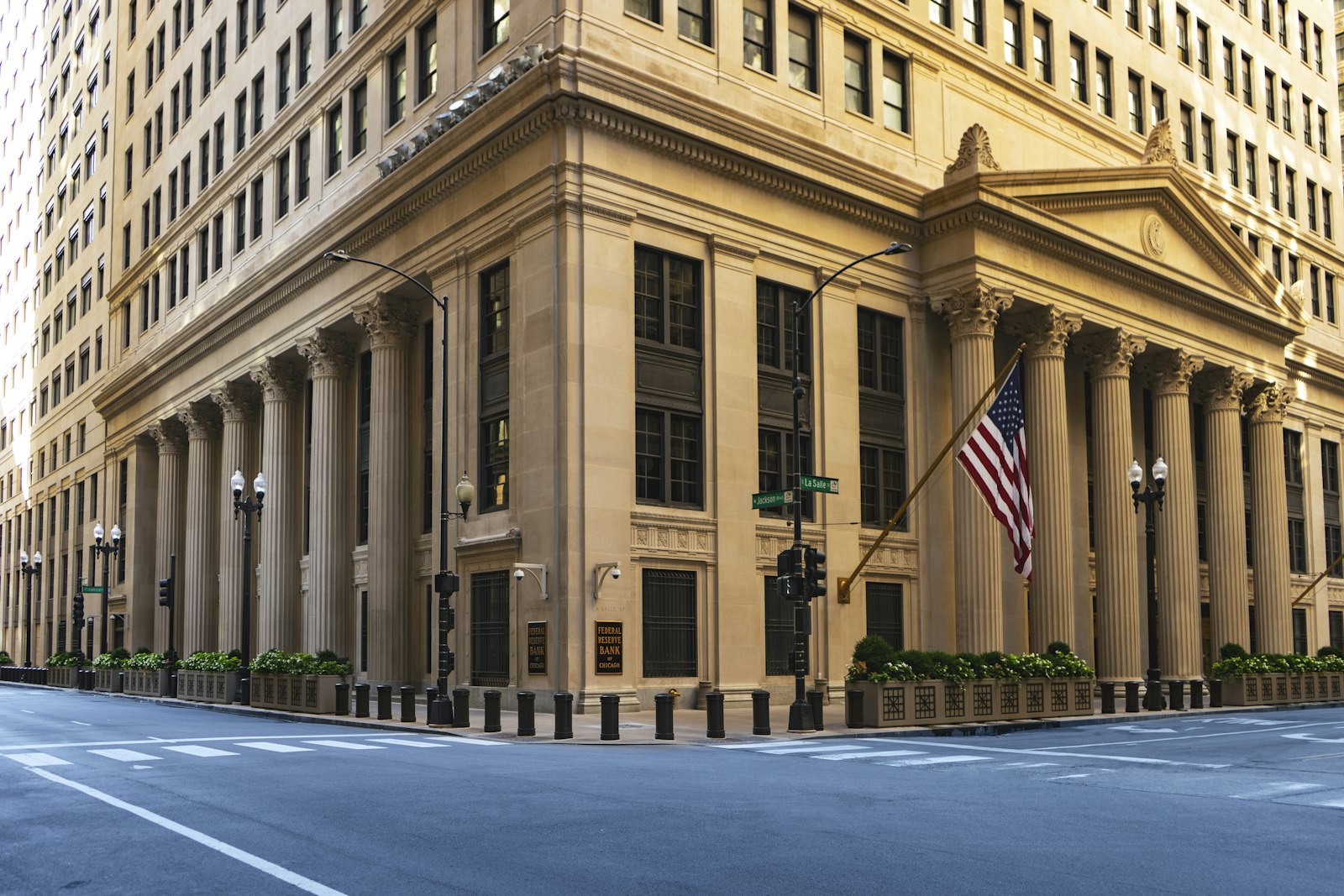 Federal Reserve Bank of Chicago building facade with columns and an American flag