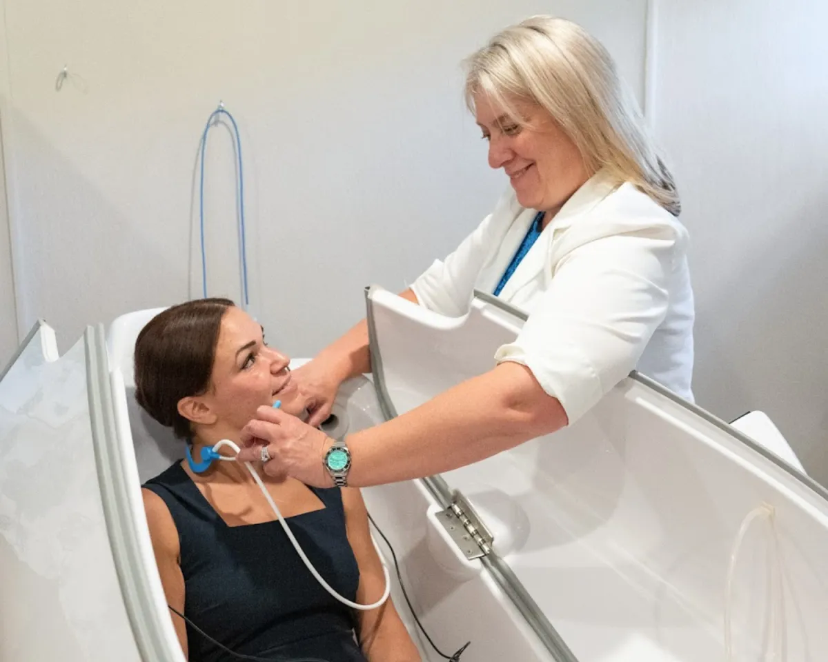 person sitting on chair in front of tree
