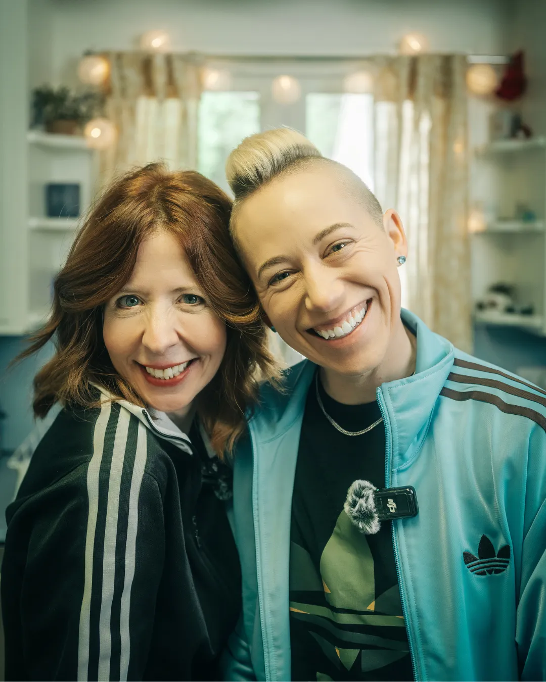 Sepia-toned portrait of two smiling women, Drea Gordon and Joanna Lohman, in a casual setting.
