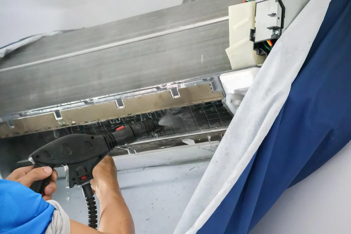 a man cleaning the duct