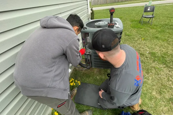 expert repairing heat pump