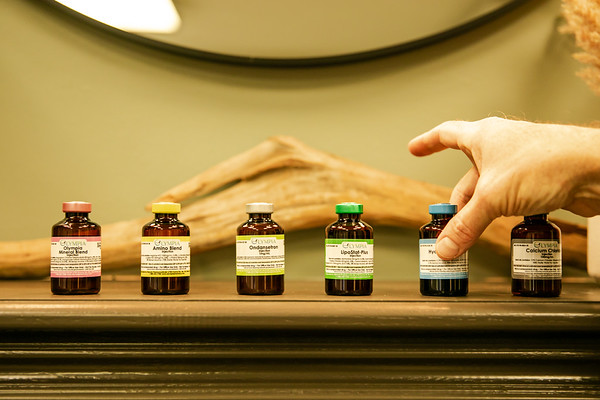 Acupuncture treatment session with practitioner inserting needles into a patient's skin, emphasizing holistic therapy at ZOVA Chiropractic Rehab Center.