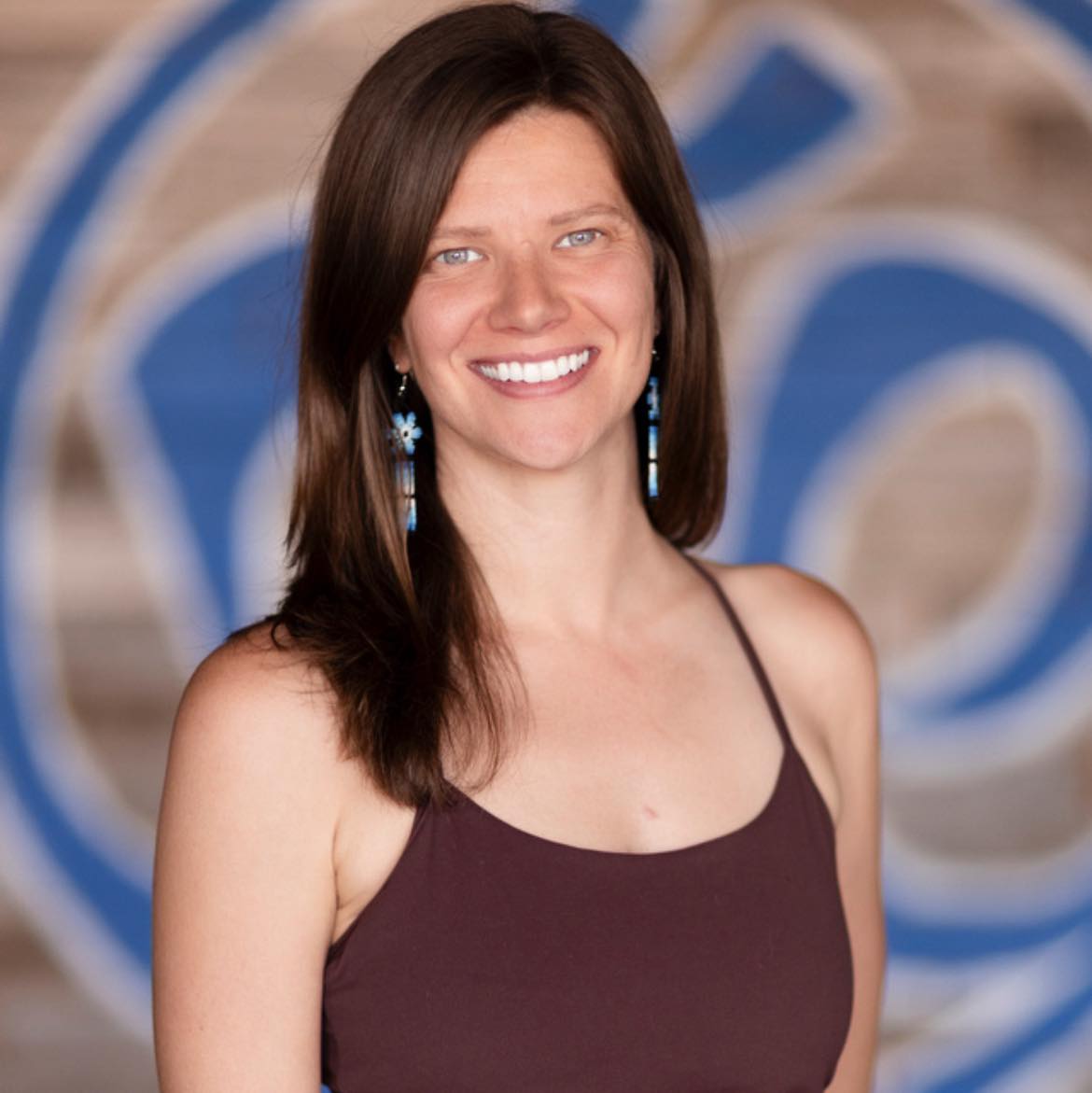 Person demonstrating exercise therapy on a red mat, assisted by a trainer, emphasizing rehabilitation and personalized care at ZOVA Chiropractic Rehab Center.