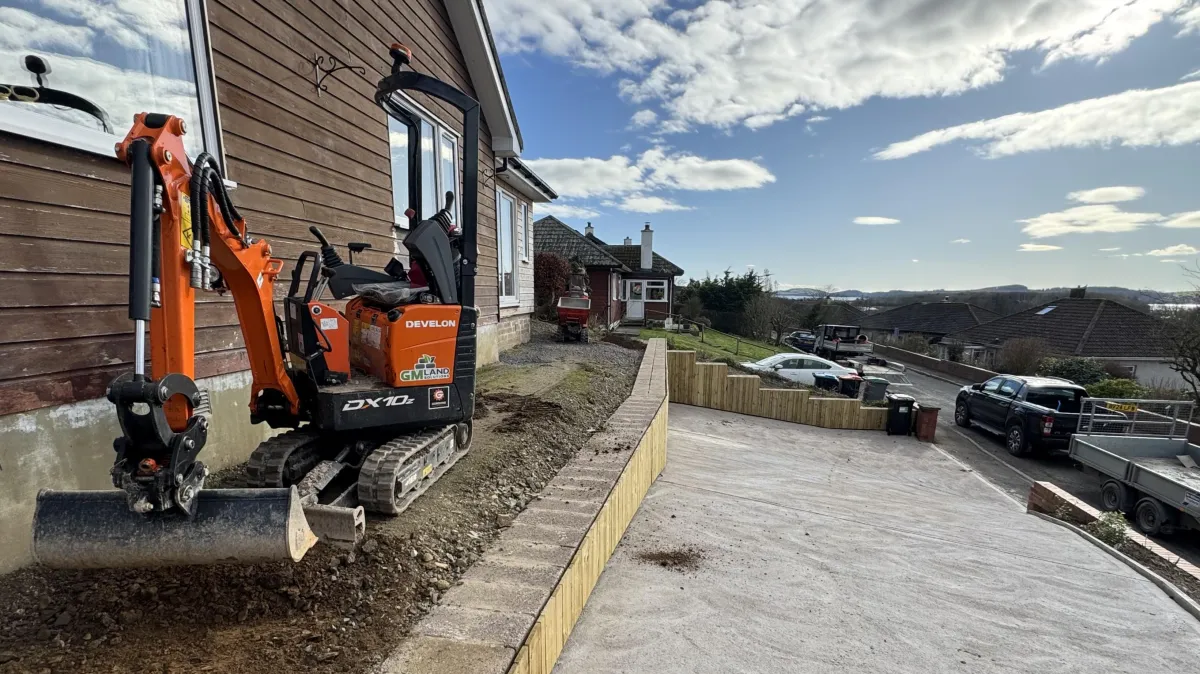 JF Groundworks compact excavator supporting GW Davidson with concrete driveway and foundation preparation in Dumfries and Galloway