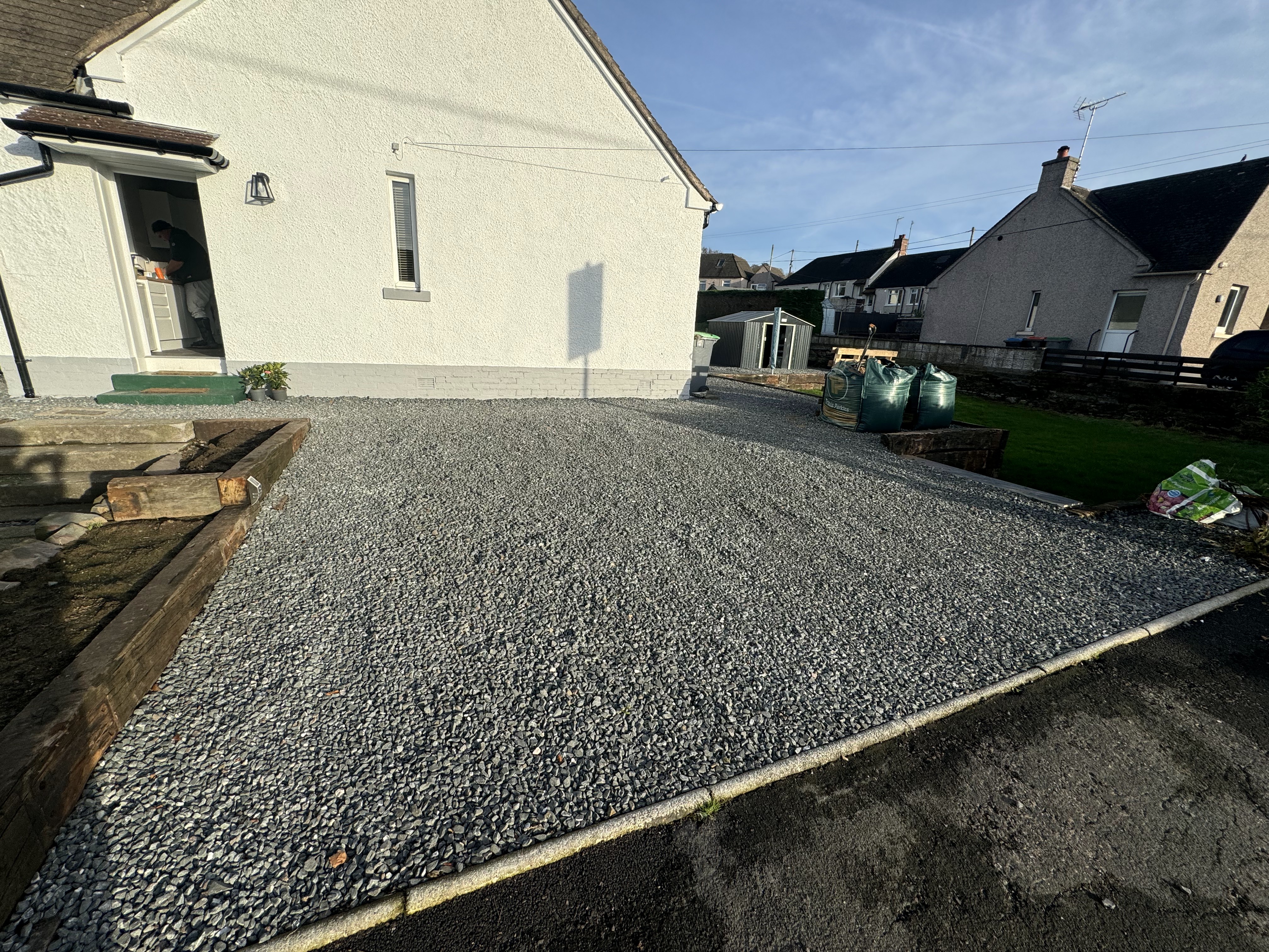 Completed gravel area by JF Groundworks showing a clean, practical finish beside a residential property