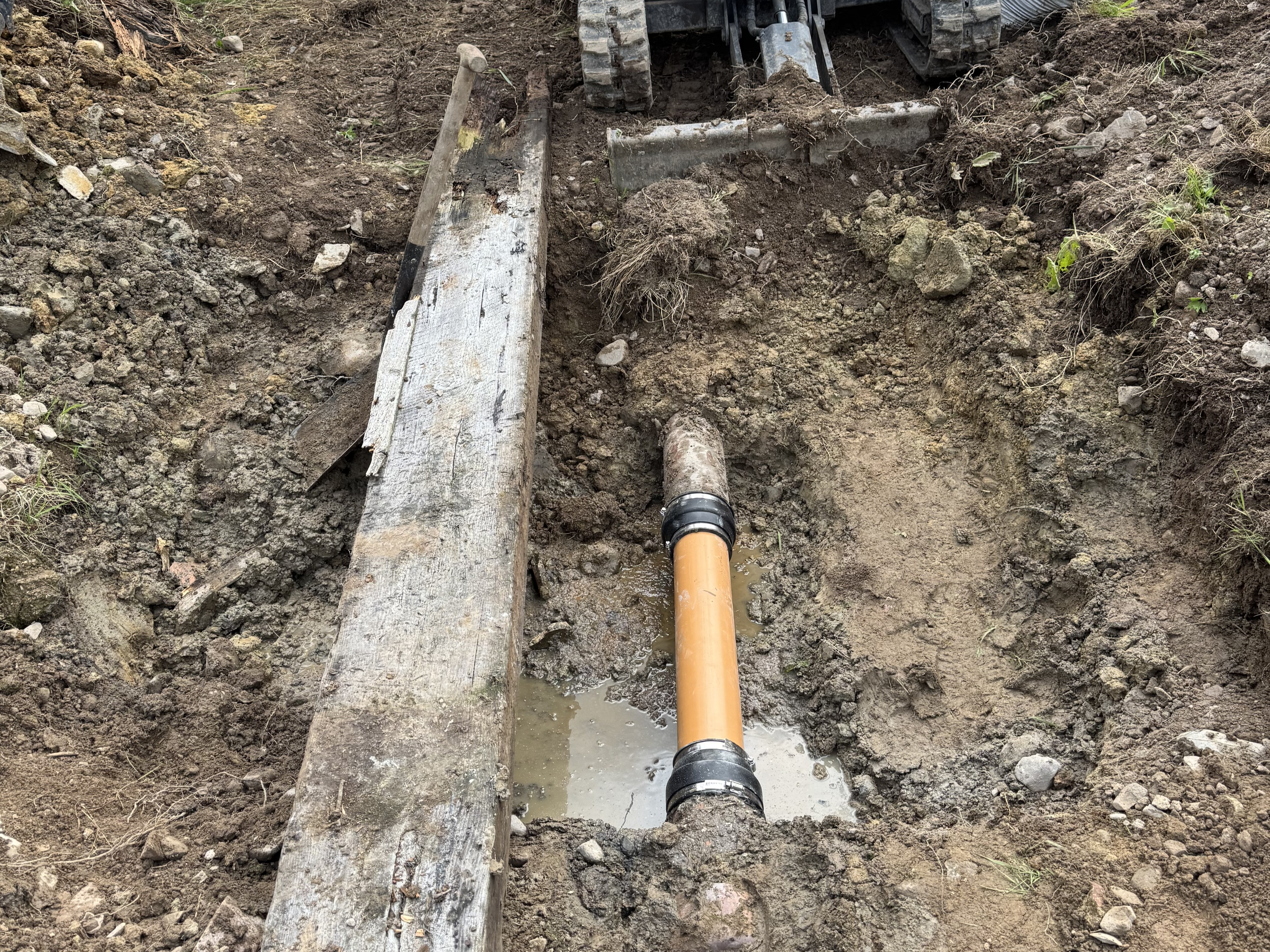 Sewer line repair by JF Groundworks showing replacement pipe installed during drainage excavation works