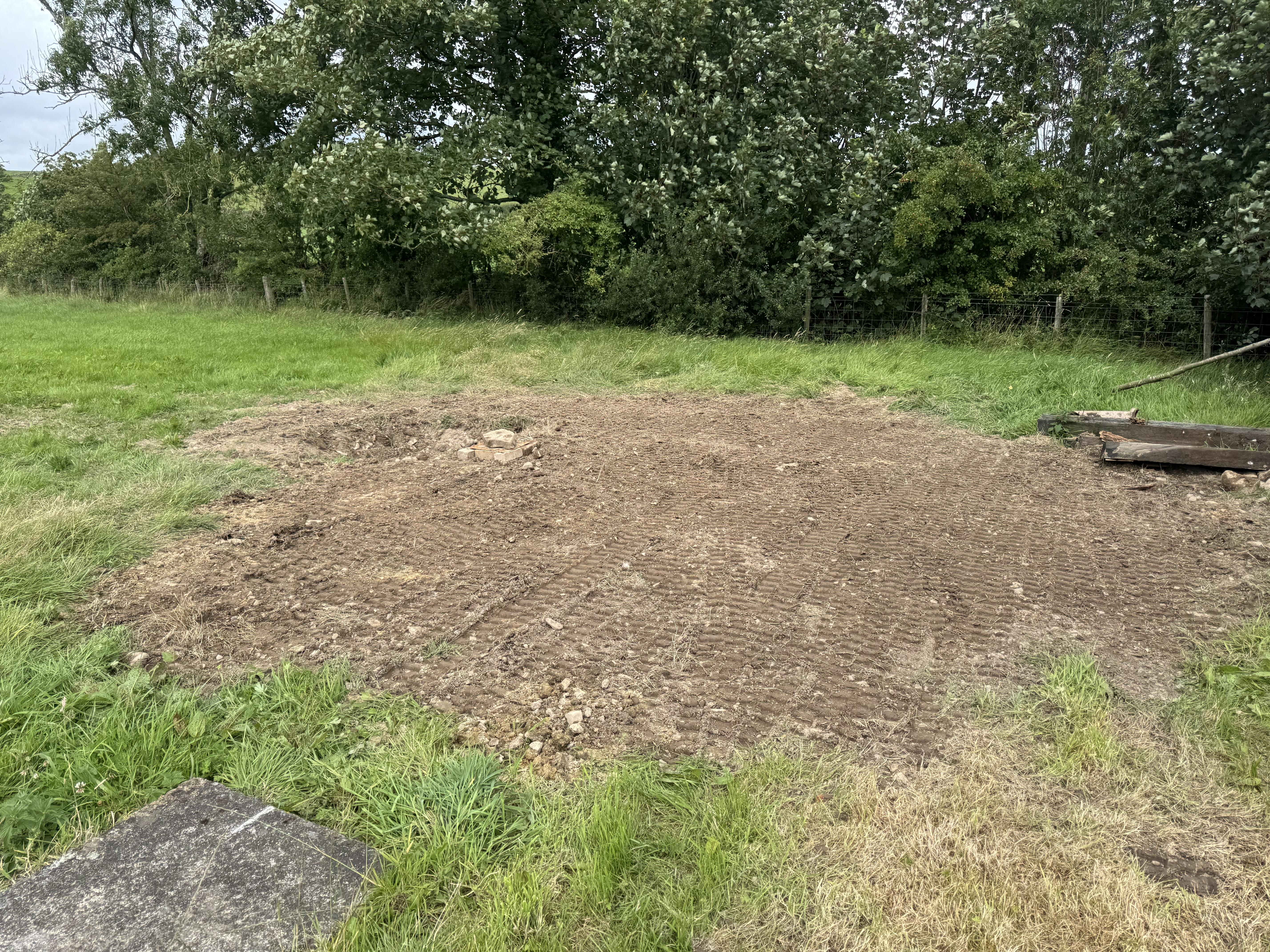 Completed sewer line repair by JF Groundworks showing reinstated ground after excavation and drainage works