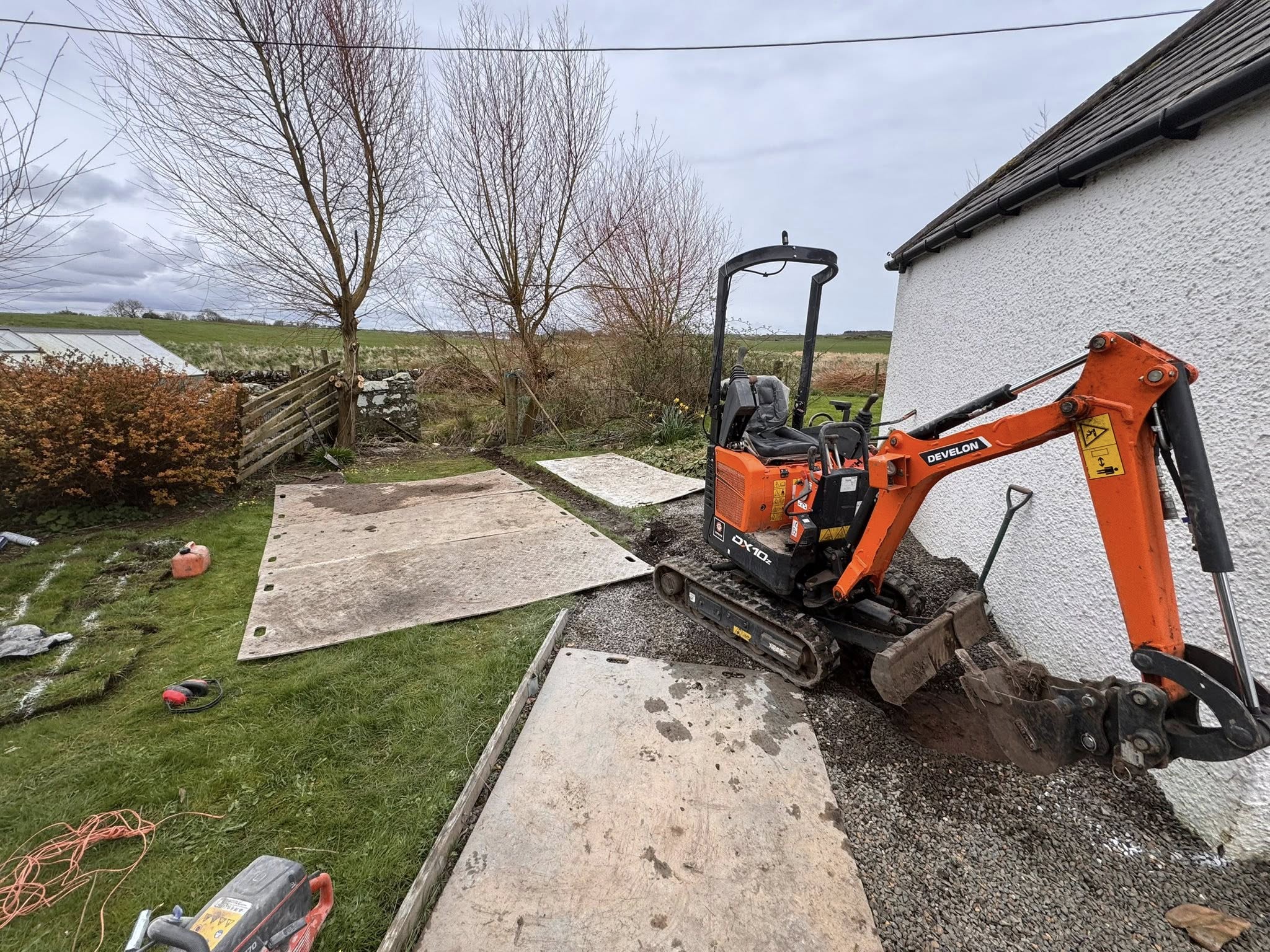 Residential drainage works in Kirkcudbright by JF Groundworks showing Develon DX10z excavator preparing the site for drainage installation