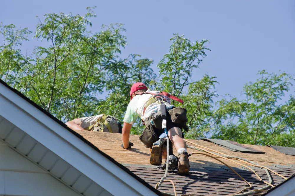 Roofing contractor inspecting a residential roof