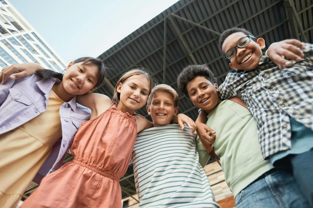 children smiling an hugging