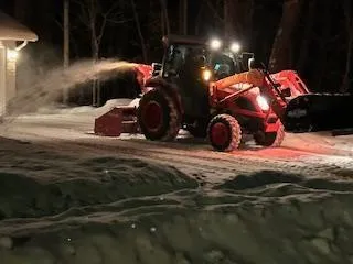 green and brown tractor on snow covered ground during daytime