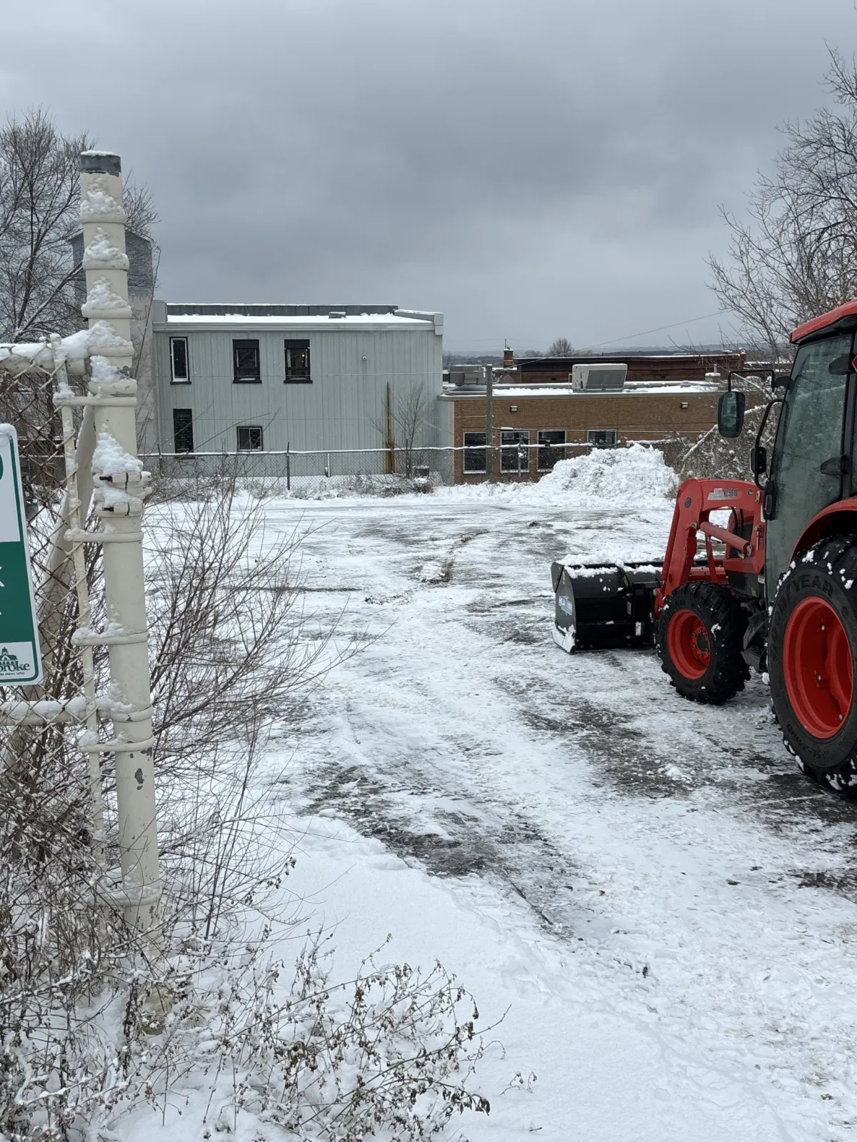 green and brown tractor on snow covered ground during daytime