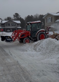 a tractor with a plow in the snow