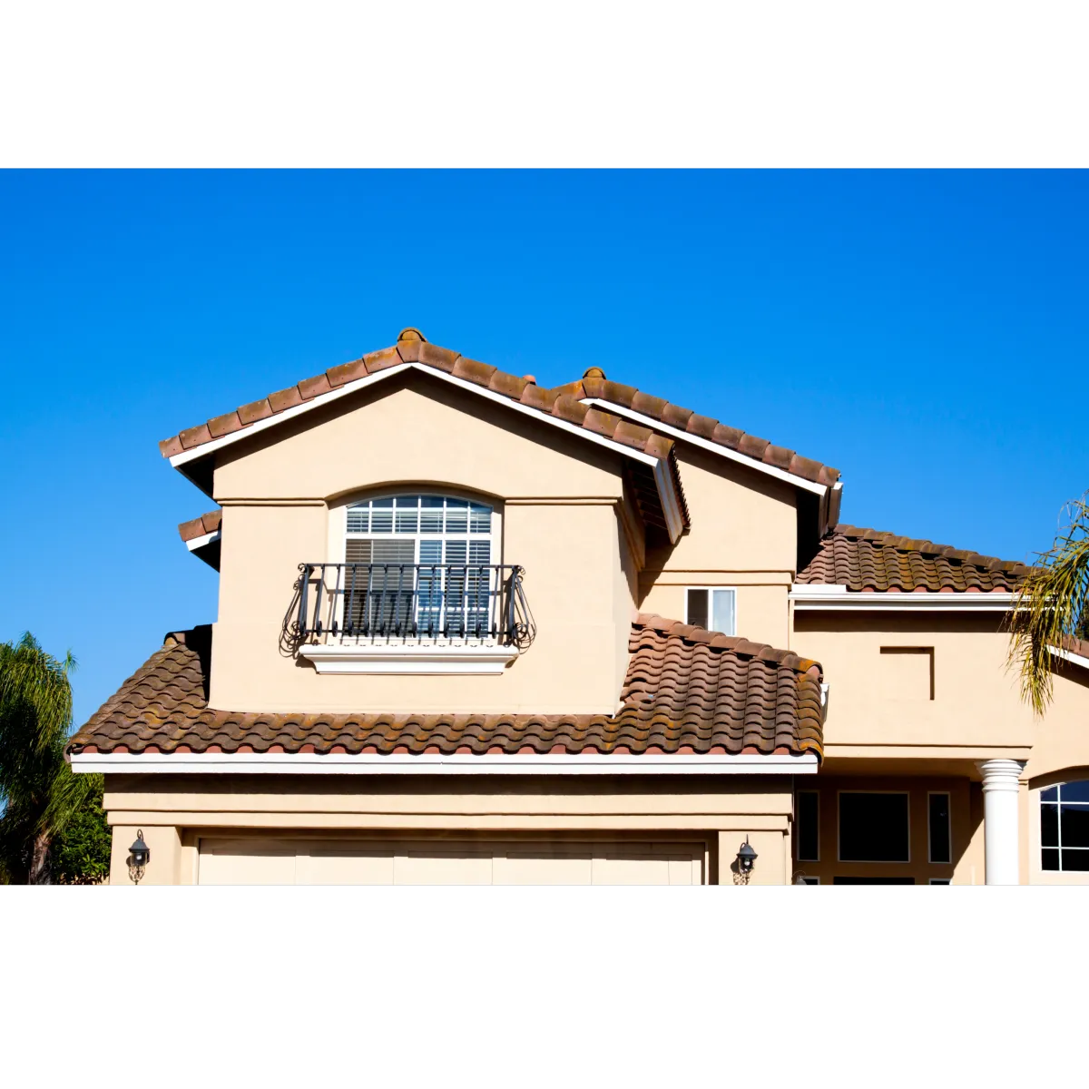 Tan stucco on house with one window